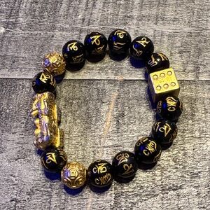 Feng Shui Pixiu bracelet featuring black obsidian mantra beads and a dice bead